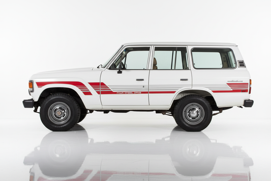 White Land Cruiser FJ 60 with red and silver stripes facing left